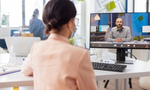 Woman in new normal office listening man talking